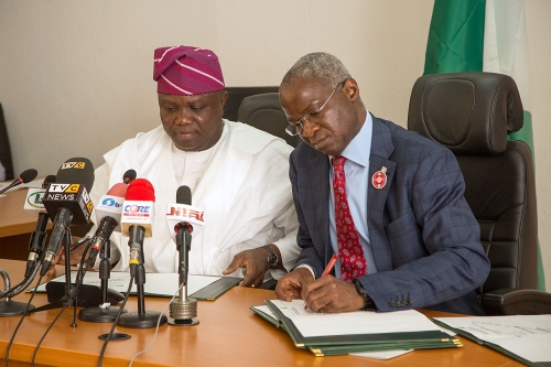 Hon Minister of Power Works  Housing Mr Babatunde FasholaSANright  and Govern or of Lagos State Mr Akinwunmi Ambodeleft during the Formal Handing Over of the Presidential Lodge Marina Lagos to the Government of Lagos State at the Ministry of Power Works  Housing Headquarters Mabushi Abuja on Tuesday 12th December 2017