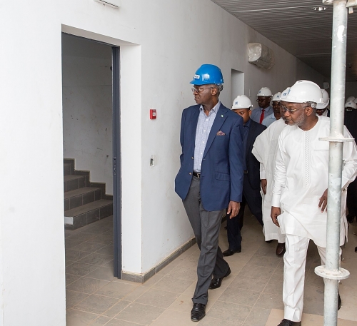 Hon Minister of Power Works  Housing Mr Babatunde FasholaSANleft and Acting Chairman Economic and Financial Crimes Commission EFCC Mr Ibrahim Maguright during the Ministers inspection of the EFCCs New Office Building at the Airport Road Jabi Abuja on Monday 22nd January 2018