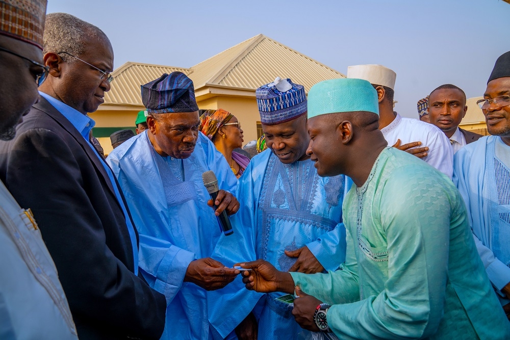 Hon  Minister of Works and Housing  Mr Babatunde Fashola SAN  2nd  left   Minister of State in the Ministry  Engr  Abubukar Aliyu  left   Governor of Gombe State  Alhaji Muhammadu Inuwa Yahaya 2nd  right  watch with keen interest as Chairman  Board of Directors FMBN  Dr  Adewale Adeeyo middle    presents    keys to one of the beneficiaries  Shuaibu Sani Bilayabu  right    during the Commissioning of Gombe State Investment Housing Estate Under the Federal Mortgage Bank of Nigeria FMBN  Estate Development Loan  EDL  Window at the Project Site  along Dukku Road  Gombe  Gombe State on Thursday  20th  February 2020