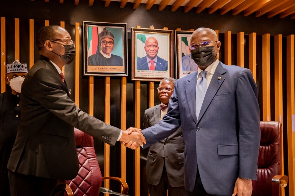 Hon. Minister of Works and Housing, Mr. Babatunde Fashola, SAN(right)  congratulating the newly sworn in CEO/ Managing Director, Federal Mortgage Bank of Nigeria(FMBN), Mr Hamman Madu(2nd left) shortly after his  inauguration as the CEO/Managing Director  of the Federal Mortgage Bank of Nigeria(FMBN) at the Ministry of Works and Housing Headquarters, Mabushi, Abuja on Thursday 21st April 2022. 