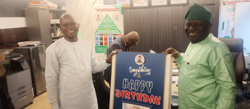 The Permanent Secretary, Federal Ministry of Housing and Urban Development, Dr. Marcus O. Ogunbiyi being presented with a birthday card on the celebration of his birthday at the Ministry’s Headquarter, Mabushi, Abuja.