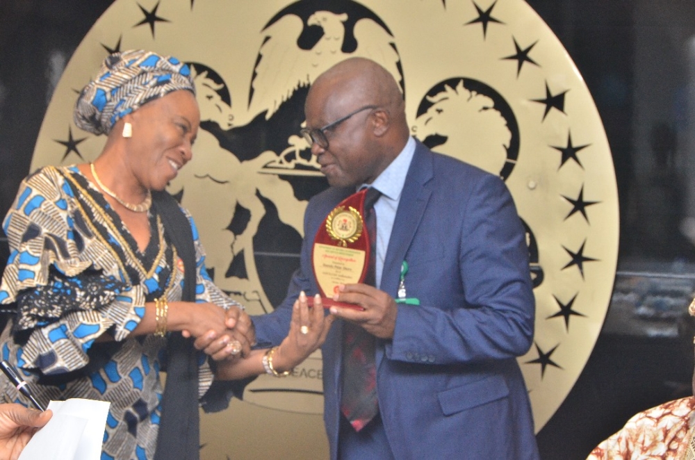 Presentation of award by the Hon Minister Arch. Ahmed Dangiwa, the Permanent Secretary Dr. Marcus Ogunbiyi and the National Servicom Coordinator at the Presidency to some Directors and  management staff of the Ministry in celebration of the 2024 Servicom Service Week at the Ministry's Conference Room, Mabushi, Abuja on the 7th October, 2024.